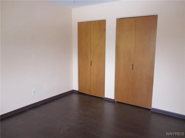 31 Park Lane Ct, Amherst, NY 14221 - unfurnished bedroom featuring dark wood finished floors and baseboards