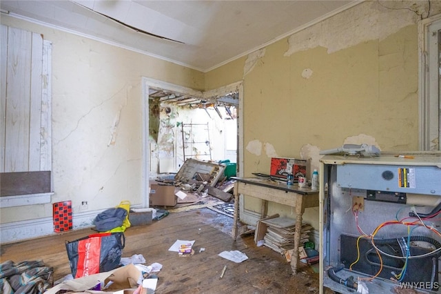 miscellaneous room with ornamental molding and wood finished floors