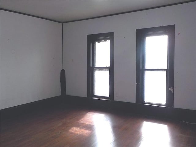 unfurnished room with wood finished floors