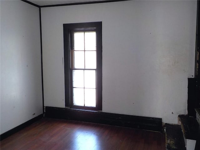 unfurnished room with dark wood finished floors