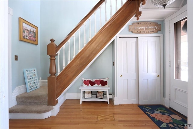 stairs with baseboards and wood finished floors