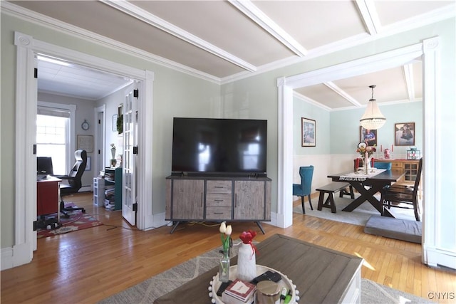 living room with crown molding and wood finished floors