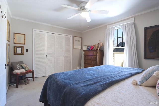 bedroom with carpet, a closet, a ceiling fan, and crown molding