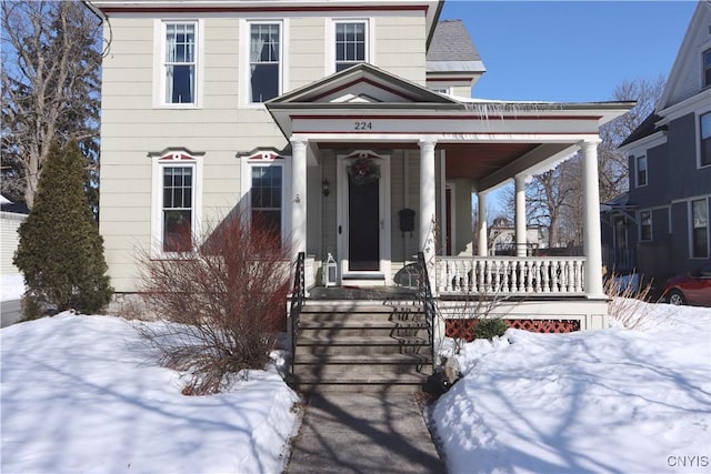 view of front of property featuring a porch and a shingled roof