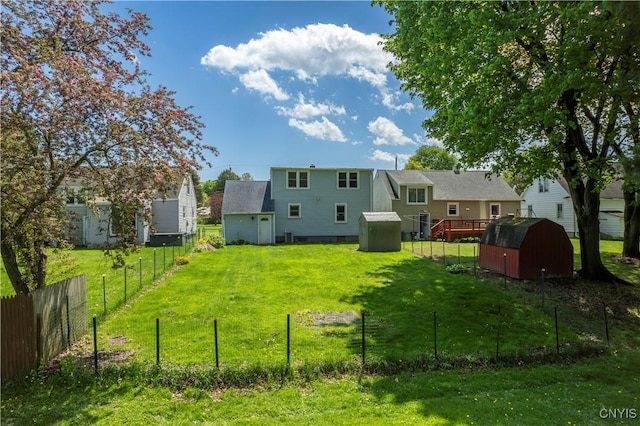 view of yard with a storage shed, fence, and an outdoor structure