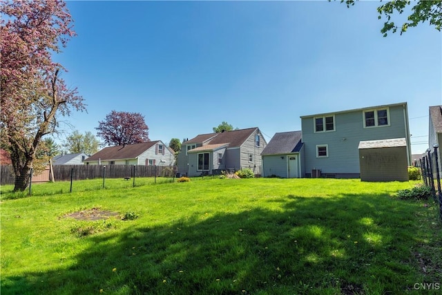 view of yard featuring fence and a residential view