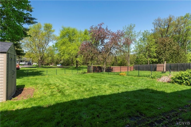 view of yard with an outdoor structure and fence