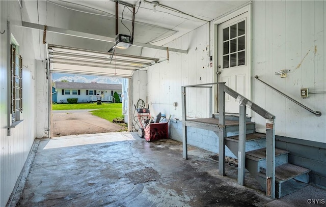 garage featuring wooden walls and a garage door opener