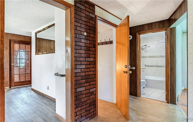 hall featuring wood walls and wood finished floors