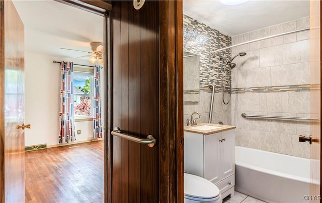 bathroom featuring ceiling fan, toilet, visible vents, vanity, and shower / bathing tub combination