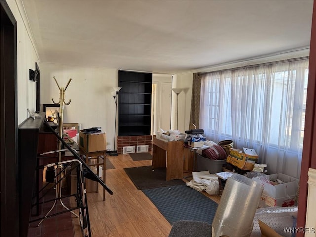 interior space featuring ornamental molding and wood finished floors