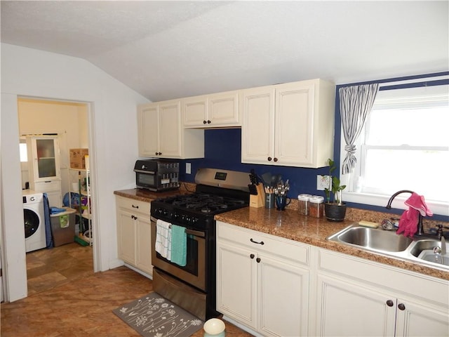 kitchen featuring lofted ceiling, washer / clothes dryer, a sink, black microwave, and stainless steel gas stove