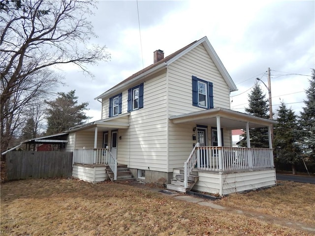 view of front of property featuring a porch and a chimney