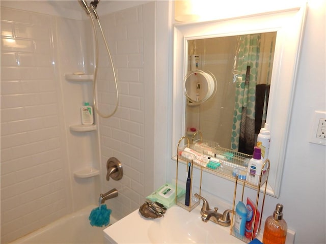 bathroom featuring shower / bath combo with shower curtain and a sink