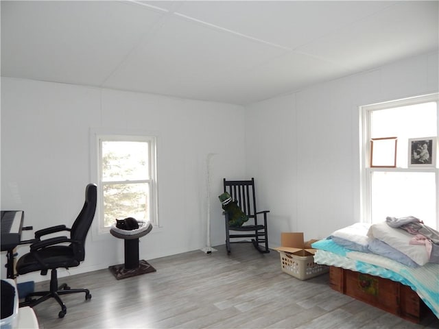 office area with a decorative wall and wood finished floors