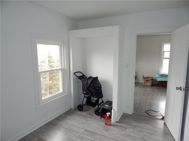 unfurnished room featuring baseboards, wood finished floors, and ornamental molding