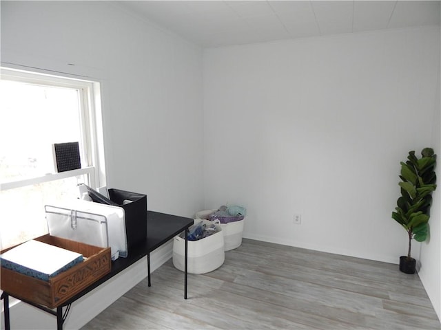 home office featuring light wood-type flooring and ornamental molding