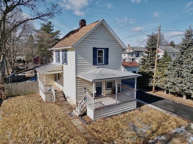 view of front of home with a porch and a chimney