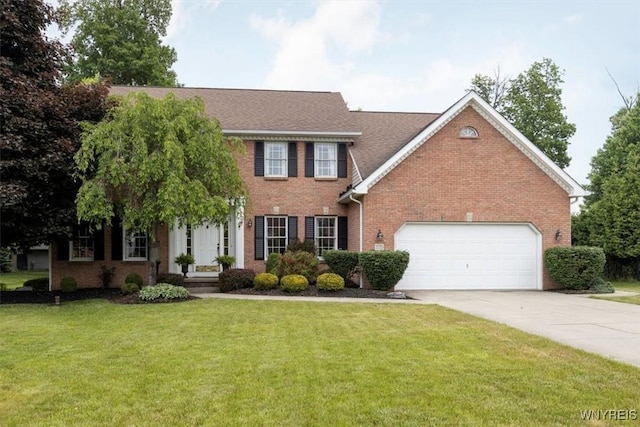 colonial inspired home with a shingled roof, brick siding, driveway, and a front lawn