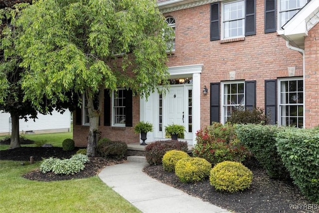 property entrance featuring brick siding