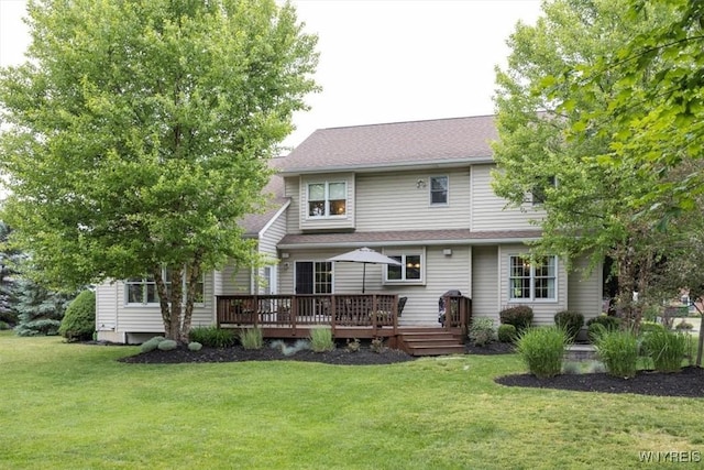 back of house featuring a lawn and a wooden deck