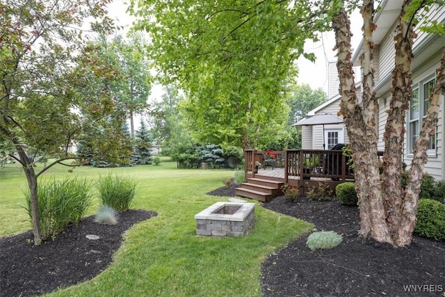 view of yard with an outdoor fire pit and a deck