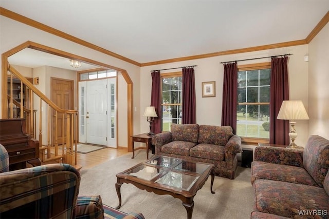 living area featuring baseboards, stairway, ornamental molding, wood finished floors, and an inviting chandelier