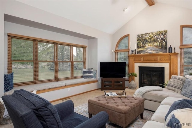 carpeted living room featuring high vaulted ceiling, a glass covered fireplace, beam ceiling, and baseboards