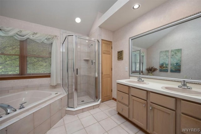 full bathroom featuring a garden tub, vaulted ceiling, a sink, and a shower stall