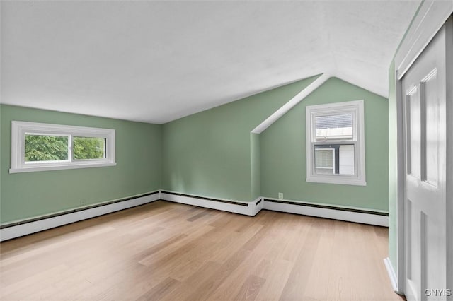 bonus room featuring lofted ceiling, plenty of natural light, and wood finished floors