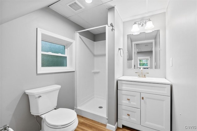 full bath featuring toilet, wood finished floors, vanity, visible vents, and a stall shower