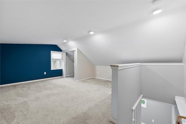 bonus room featuring vaulted ceiling, carpet flooring, and baseboards