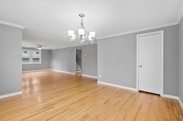 spare room featuring baseboards, light wood finished floors, and stairs