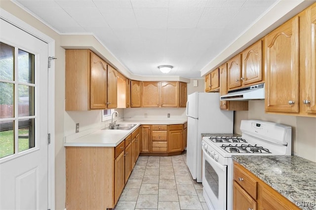 kitchen featuring light tile patterned floors, light countertops, a sink, white appliances, and under cabinet range hood