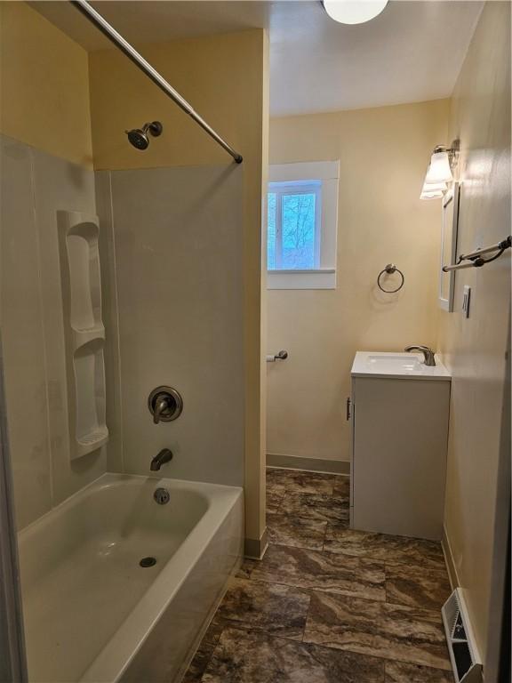 full bathroom with visible vents, vanity, baseboards, and shower / bathtub combination