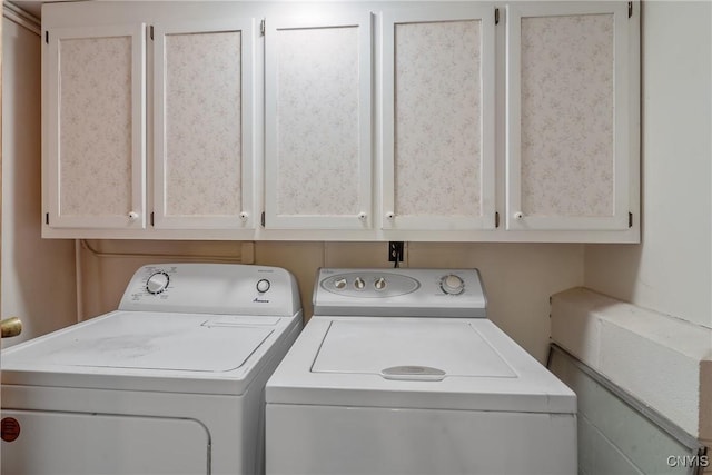 clothes washing area with cabinet space and washer and clothes dryer