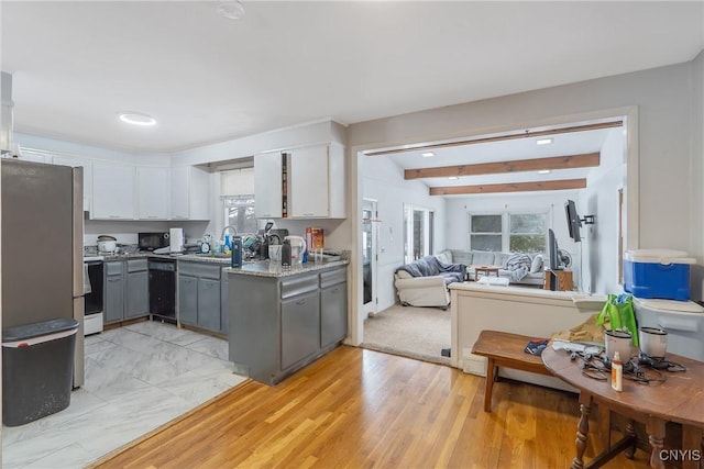 kitchen featuring electric stove, gray cabinets, freestanding refrigerator, white cabinetry, and beamed ceiling