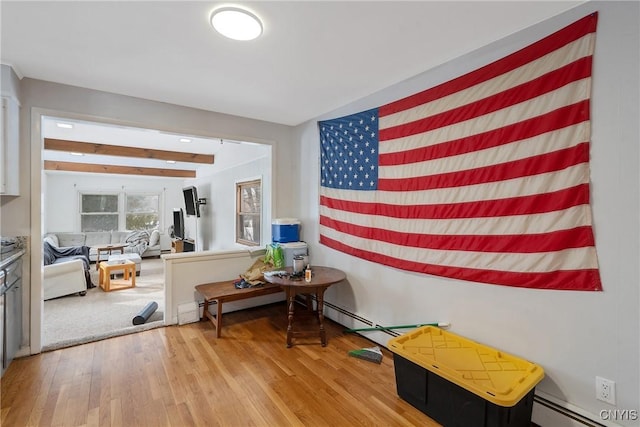 hall with a baseboard radiator and wood finished floors