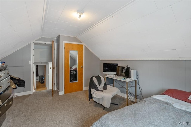 bedroom featuring lofted ceiling and baseboards