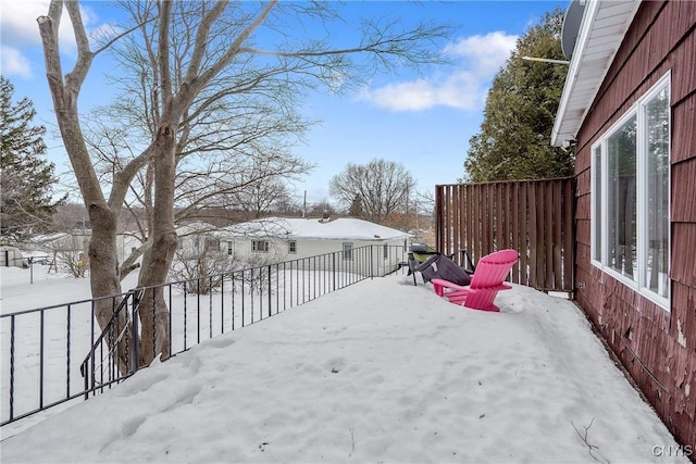 yard covered in snow with fence