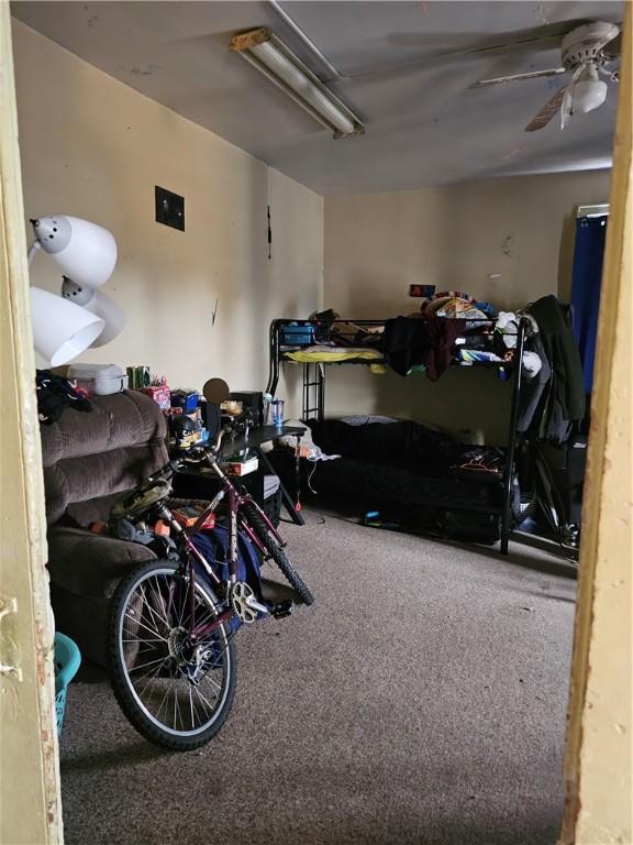 interior space with a garage and carpet flooring