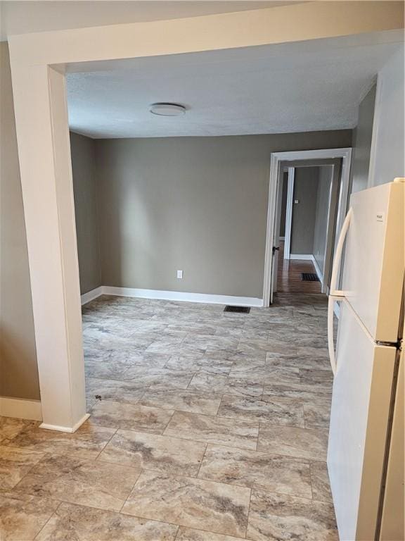 spare room featuring visible vents and baseboards