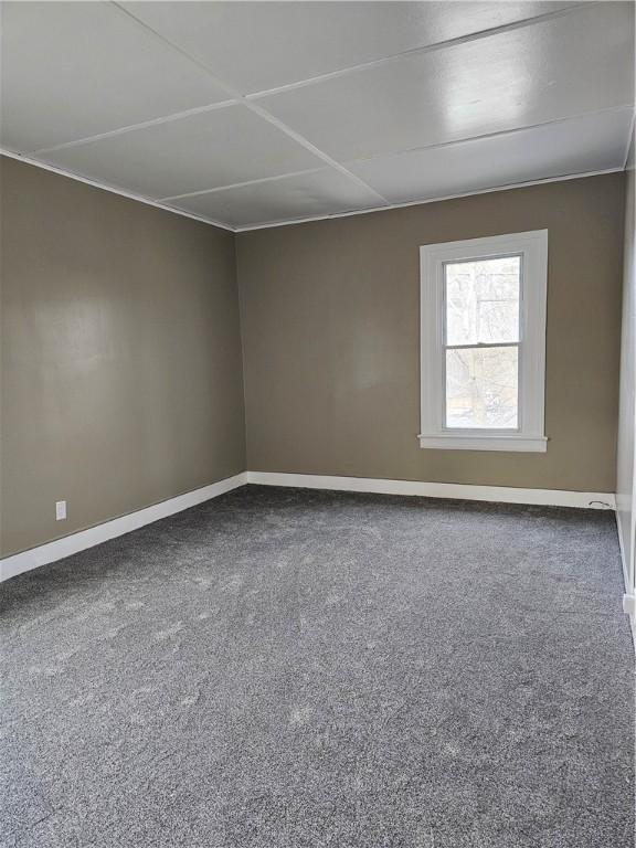 unfurnished room featuring carpet flooring and baseboards