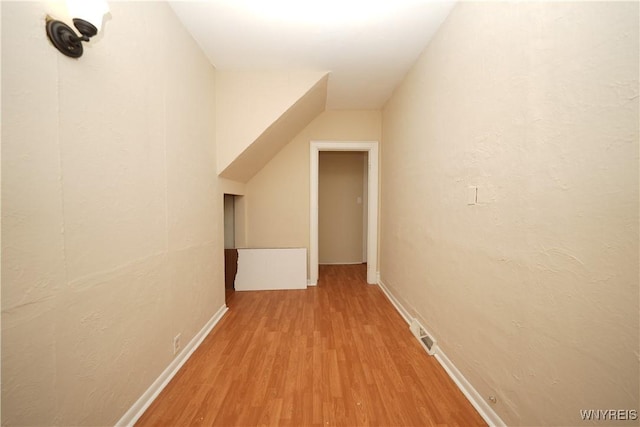 hallway featuring wood finished floors and visible vents