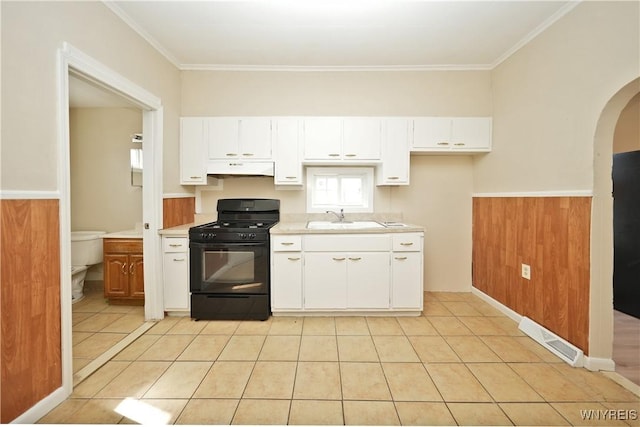 kitchen with visible vents, wainscoting, black gas range oven, under cabinet range hood, and a sink