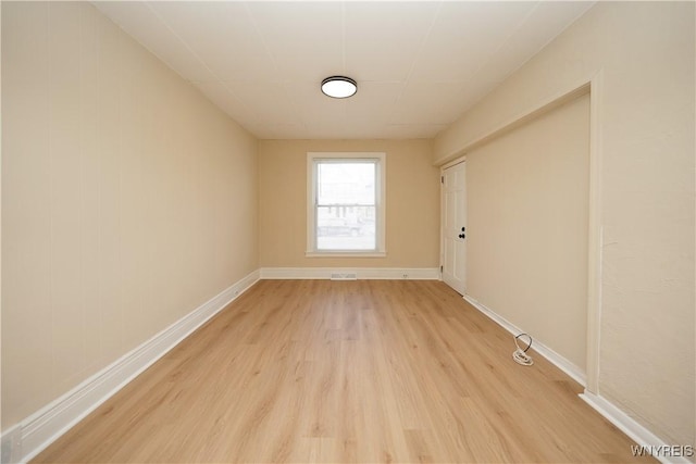 unfurnished room with light wood-style floors and baseboards