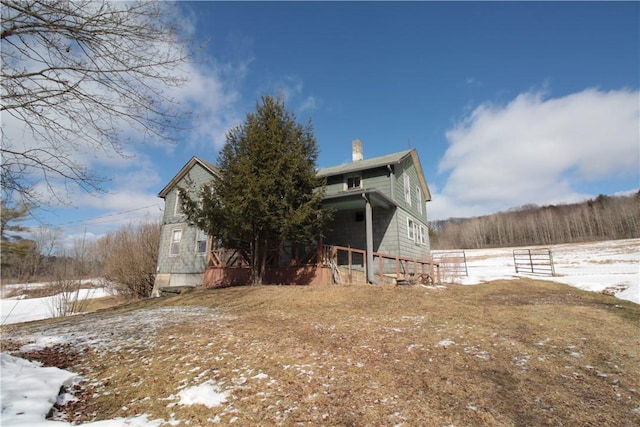 snow covered property featuring a chimney