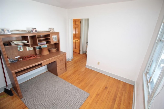 office featuring light wood-style floors and baseboards