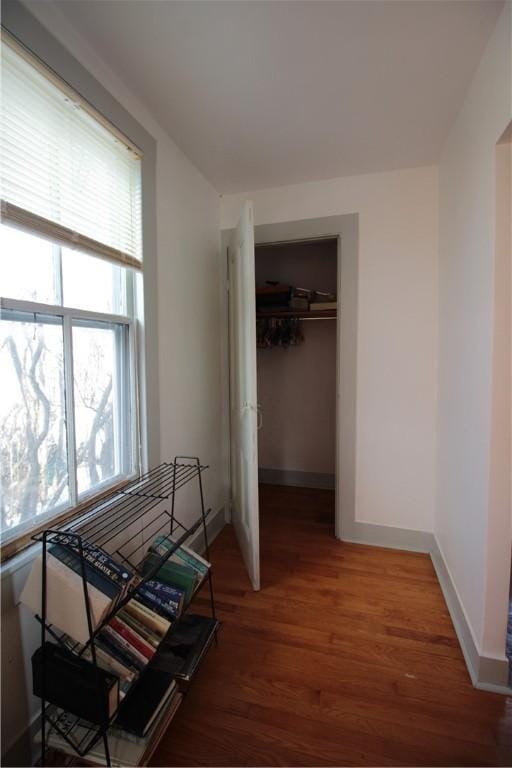 bedroom featuring light wood finished floors, a closet, and baseboards