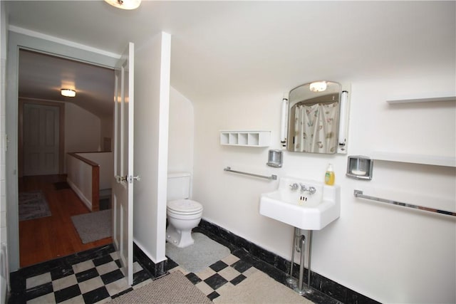 full bath with toilet, baseboards, a sink, and tile patterned floors